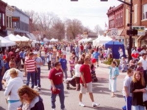 Lots of visitors and booths fill the street at Wakarusa Maple Syrup Festival